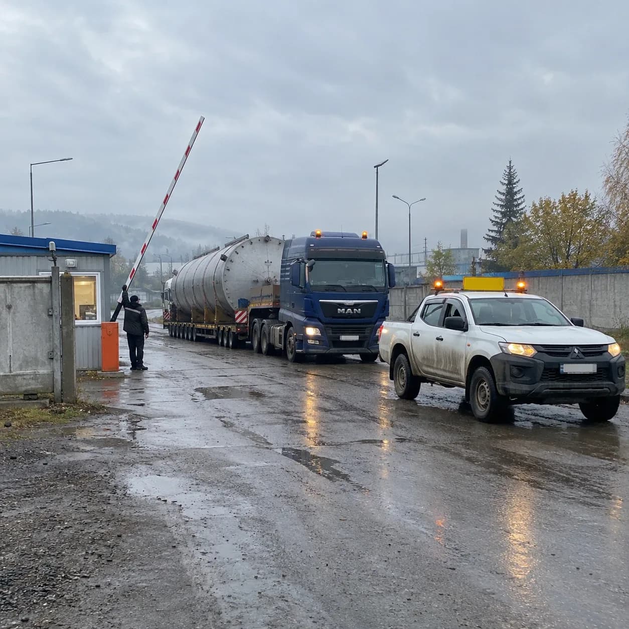 Тягач с ёмкостью и машина сопровождения вместе выезжают с завода